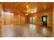 Inviting living room with wood paneling, brick-patterned flooring, and a front door at 6051 Valley Spring Dr, Brooksville, FL 34601