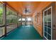 Relaxing screened in patio features wood walls, a ceiling fan, and views of the yard at 6051 Valley Spring Dr, Brooksville, FL 34601