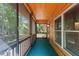 View of a charming, screened-in porch with wood paneled walls and flooring at 6051 Valley Spring Dr, Brooksville, FL 34601