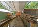 Long, covered wooden walkway leading to multiple building entrances of the property with natural lighting at 6051 Valley Spring Dr, Brooksville, FL 34601