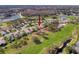 Beautiful aerial view of a home surrounded by lush greenery, lakes, and a golf course at 9519 Green Needle Dr, New Port Richey, FL 34655