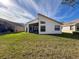 Backyard view showcasing the home’s architectural style at 9519 Green Needle Dr, New Port Richey, FL 34655