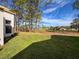 Spacious backyard with lush green grass and mature trees, providing a serene and private outdoor space at 9519 Green Needle Dr, New Port Richey, FL 34655