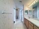 Bright bathroom featuring a vanity with sink, toilet, and glass enclosed shower at 9519 Green Needle Dr, New Port Richey, FL 34655