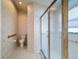 Bathroom featuring a toilet and glass enclosed shower with gold trim at 9519 Green Needle Dr, New Port Richey, FL 34655