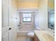 Bright bathroom featuring a shower-tub combo with safety bars and window for natural light at 9519 Green Needle Dr, New Port Richey, FL 34655