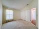 Neutral bedroom with a large window, closet, and access to other rooms at 9519 Green Needle Dr, New Port Richey, FL 34655