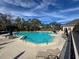 Large community pool surrounded by lounge chairs and umbrellas, perfect for relaxation and recreation at 9519 Green Needle Dr, New Port Richey, FL 34655