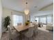 Inviting dining area with a modern chandelier and a large table with seating for six at 9519 Green Needle Dr, New Port Richey, FL 34655