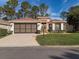 Charming single-story home with a well-manicured lawn and a spacious two-car garage at 9519 Green Needle Dr, New Port Richey, FL 34655