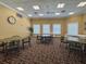 Cozy game room with tables, chairs, and a clock provides a relaxed space for recreation and socializing at 9519 Green Needle Dr, New Port Richey, FL 34655