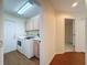 Laundry room with white washer and dryer, cabinets, and access to other rooms at 9519 Green Needle Dr, New Port Richey, FL 34655
