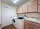 Well-equipped laundry room featuring a washer, dryer, sink, and ample storage cabinets at 9519 Green Needle Dr, New Port Richey, FL 34655