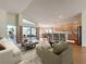 Open-concept living room featuring wood floors, modern furnishings, and sliding glass doors to the lanai at 9519 Green Needle Dr, New Port Richey, FL 34655