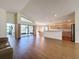Spacious living room with wood floors, open layout, and access to the kitchen and outdoor space at 9519 Green Needle Dr, New Port Richey, FL 34655