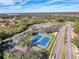 Aerial view of community tennis courts, surrounded by mature trees and lush landscaping at 9519 Green Needle Dr, New Port Richey, FL 34655