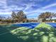 Well-maintained community tennis courts with blue and green surfaces, providing a great space for sports at 9519 Green Needle Dr, New Port Richey, FL 34655