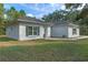 Exterior view of a home with a well-manicured lawn, landscaping, and a neutral colored exterior at 11085 Stilt Ave, Brooksville, FL 34614