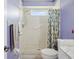 Well lit bathroom featuring tiled walk-in shower, with safety bars, a floral shower curtain, and a white marble vanity at 11532 Holly Ann Dr, New Port Richey, FL 34654