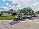 Exterior view of community club house with lush landscaping and golf carts at 11532 Holly Ann Dr, New Port Richey, FL 34654