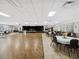 Large open event space featuring a stage, dance floor, and round tables with chairs at 11532 Holly Ann Dr, New Port Richey, FL 34654