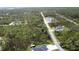 Expansive aerial view showcases the neighborhood's location, surrounded by lush greenery and serene landscapes at 12149 Chapman Ave, Port Charlotte, FL 33953
