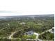 Breathtaking aerial view of home and its tranquil, wooded surroundings providing a sense of privacy and seclusion at 12149 Chapman Ave, Port Charlotte, FL 33953