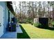 Landscaped backyard offering a peaceful retreat with wooded views at 12149 Chapman Ave, Port Charlotte, FL 33953