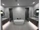 Spacious bathroom with dual vanities, soaking tub, and modern fixtures, offering a spa-like experience at 12149 Chapman Ave, Port Charlotte, FL 33953