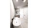 Bright bathroom featuring a modern vanity, soaking tub, and dual entry doors at 12149 Chapman Ave, Port Charlotte, FL 33953