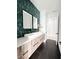 Stylish bathroom showcasing double sinks, a tile accent wall, and modern fixtures at 12149 Chapman Ave, Port Charlotte, FL 33953