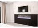 Bedroom features a modern fireplace and stylish accent wall at 12149 Chapman Ave, Port Charlotte, FL 33953