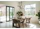 Bright dining room features modern light fixture and a large window overlooking the lush outdoors at 12149 Chapman Ave, Port Charlotte, FL 33953