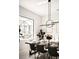 Dining room with elegant lighting and view of a beautifully landscaped yard at 12149 Chapman Ave, Port Charlotte, FL 33953