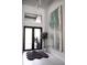 Bright entryway boasts high ceilings, modern lighting, and a striking art piece at 12149 Chapman Ave, Port Charlotte, FL 33953
