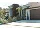 Modern home exterior with clean lines, wood accents, and manicured landscaping with decorative plant life at 12149 Chapman Ave, Port Charlotte, FL 33953