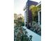 Exterior side view of a modern home with a brown accent panel and manicured landscaping at 12149 Chapman Ave, Port Charlotte, FL 33953