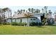 Beautiful single-story home with lush landscaping and a well-manicured lawn at 12149 Chapman Ave, Port Charlotte, FL 33953