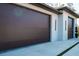 Contemporary home with two-car garage featuring modern dark doors and clean lines at 12149 Chapman Ave, Port Charlotte, FL 33953