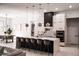 Modern kitchen with a large island, stylish pendant lighting, and sleek appliances at 12149 Chapman Ave, Port Charlotte, FL 33953