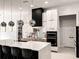 Modern kitchen featuring a large island with seating and pendant lighting at 12149 Chapman Ave, Port Charlotte, FL 33953