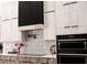 Modern kitchen with stainless steel appliances and stylish tile backsplash at 12149 Chapman Ave, Port Charlotte, FL 33953