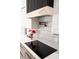 A detailed view of a modern kitchen showing a pot filler faucet and stylish backsplash at 12149 Chapman Ave, Port Charlotte, FL 33953