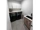 Laundry room with modern appliances, sink, and ample storage space at 12149 Chapman Ave, Port Charlotte, FL 33953