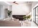Modern living room with a grey sectional couch, fireplace, electric fireplace and white grand piano at 12149 Chapman Ave, Port Charlotte, FL 33953