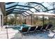 Outdoor living at its finest: Pool and spa area with lounge seating and forest backdrop at 12149 Chapman Ave, Port Charlotte, FL 33953