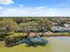 Aerial view showcasing the home's proximity to the lake in a wooded community at 7414 Heather Walk Dr, Weeki Wachee, FL 34613