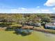 Picturesque lakeside property with mature trees, offering serene views and tranquil surroundings at 7414 Heather Walk Dr, Weeki Wachee, FL 34613