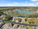 Scenic aerial view of a lakeside community with well-maintained lawns and mature trees at 7414 Heather Walk Dr, Weeki Wachee, FL 34613