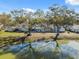 Waterfront home features a large backyard with mature trees offering picturesque views and backyard water access at 7414 Heather Walk Dr, Weeki Wachee, FL 34613